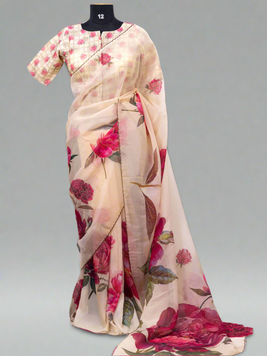 Beige saree with floral patterns on a mannequin against a white curtain background, branded 'Aurat Designs'.