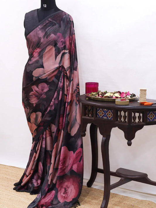 Floral saree draped over a mannequin with a decorative table in the background